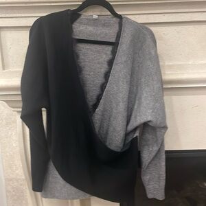 Black and grey lace trimmed criss cross thin sweater. Size large. Never worn.